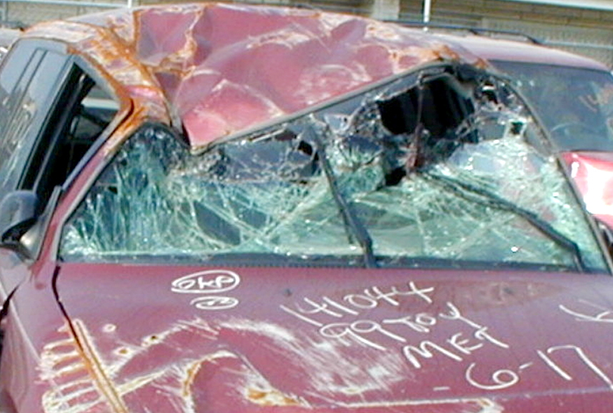 photo of wrecked car with
   buckled roof